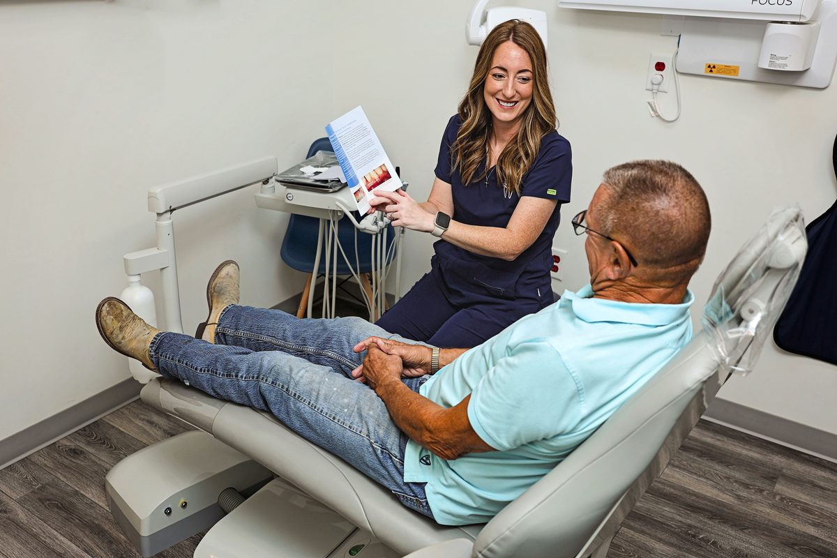 Talking through a dental visit with a patient in Whitesboro, TX